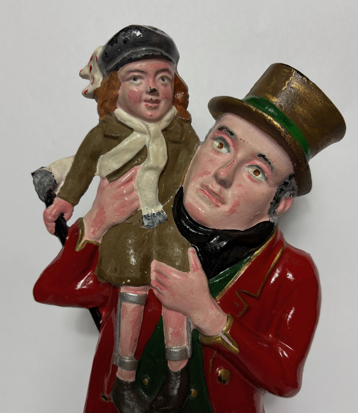 Early 20th‑century cast‑iron doorstop of Bob Cratchit & Tiny Tim from Dickens’ A Christmas Carol.